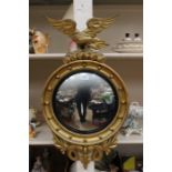 A late Regency eagle mounted convex wall mirror with gilt frame and eagle, original glass, good