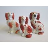 Three Staffordshire Seated Red and White Spaniels Date circa  1850-60 Size  14cm    16cm  17cm  high