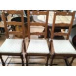 A set of six contemporary oak ladder back chairs with rush seats, together with a pair of
