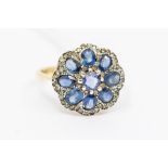 A sapphire and diamond 18ct gold and silver ring, comprising a round cut sapphire set to the