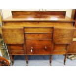 A George III mahogany sideboard, the hinged top enclosing a single section, the front with drop-leaf