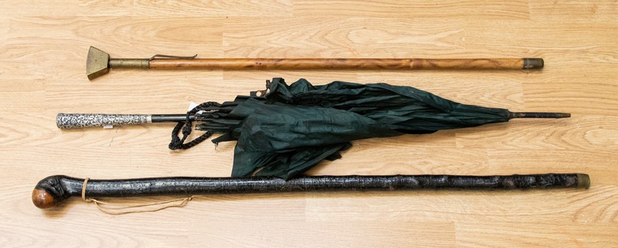 Two walking canes and a silver handled umbrella