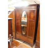 An Edwardian mahogany wardrobe, a dressing chest, a bedside cabinet and a cheval mirror (4)