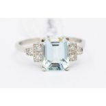 An aquamarine and diamond platinum ring, the central claw set aquamarine weighing approx 2.10carats,