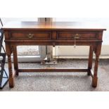 A Jacobean style oak joined side table, fitted with two drawers, raised on turned legs, 70cm high,