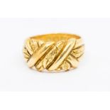 A Victorian 18ct gold fancy ring, decorated with raised foliate engraved details and polished