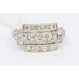 An Art Deco style diamond and platinum ring, the rectangular setting set with three rows of