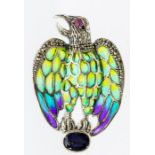 A plique a jour silver and enamel pendant/brooch in the form of an eagle, cabochon ruby set eye