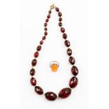 A faceted cherry coloured  Bakelite bead necklace, graduated beads, length approx 20'',  along