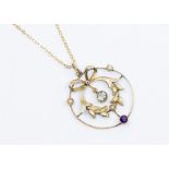 An Edwardian 9ct gold pendant, open circular design with wreath and bow to the centre suspending a