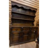 A Jacobean style oak dresser and rack, fitted with three drawers over three doors