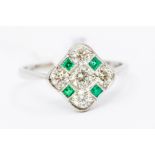 An diamond and emerald platinum dress ring, the diamond shaped mount set with a checker board of