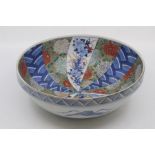 A Japanese Imari bowl, probably late Edo period, of rounded form with moulded rim, decorated with