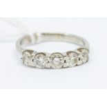 A five stone diamond and platinum ring, comprising a row of bar set brilliant cut diamonds, total