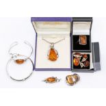 A collection of silver and amber jewellery, mostly certified amber, comprising silver bangle, silver