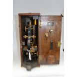 A Broadhurst Clarkson boxed microscope, early 20th Century fitted in an oak case, the microscope