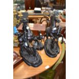 A pair of bronzed reproduction mantle/fireplace figures of man controlling a horse by Coustou, on