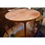 A 1970's round extendable teak dining table