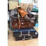 A collection of vintage suitcases and doctors bags
