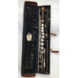Wooden flute, one section stamped 'Boosey & Co. Ltd., Makers London 23238', one section stamped '