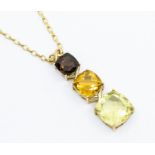 A 9ct gold three stone pendant, comprising graduated cushion cut smoky quartz, citrine, and lime