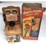 Codeg: A boxed tinplate and wooden money box, in the form of a Ranch Phone. Made in England by