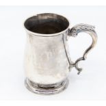 A George III silver baluster form mug, having double scroll handle with leaf thumb grip, by John