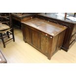 A 17th Century style traditional oak joined chest, plank top, panelled front and sides, 61cm high,