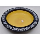 Royal Doulton: A Royal Doulton bowl, yellow centre with black rim. Floral decoration to the rim.