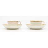 A pair of Berlin porcelain coffee cups and saucers, circa 1890, of rounded form and finely moulded