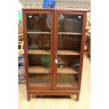 An early 20th Century mahogany finish two door glazed bookcase, possibly once the upper section of a