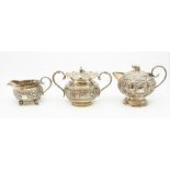 A collection of Asian white metal probably Indian teaware to include bullet shaped teapot,