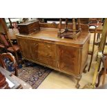 An early 20th Century Georgian style mahogany sideboard, together with a dining table raised on