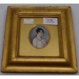 An early 19th Century portrait miniature depicting a young lady wearing a coral necklace and a coral