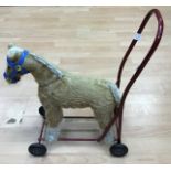 A 1950/60's Pedigree children's push along horse, straw filled and on wheels