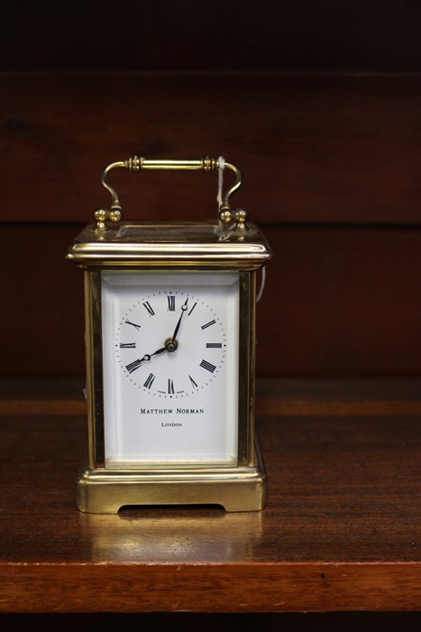 A Matthew Norman of London brass carriage clock, white enamelled dial and black Roman numerals,