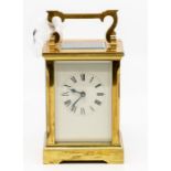 A 19th Century brass carriage clock, possibly French, white dial, four pillared movement, 13 cms