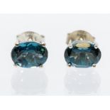 A pair of London blue topaz and silver studs, oval faceted topaz set in four claw mounts, size