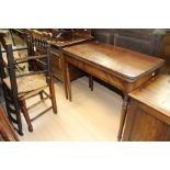 An early 19th Century mahogany fold over tea table, ebony stringing, 72.5cm high, 91cm wide, 46cm