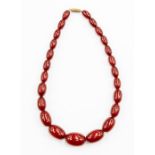 A cherry amber necklace, comprising graduated oval beads, from approx 14 x 8mm to the largest approx
