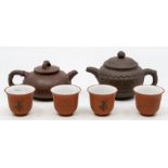 Two Chinese clay teapots with four Saki cups