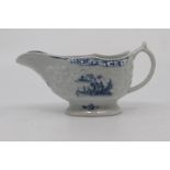 A Worcester sauce boat, circa 1760-65, of moulded oval form and painted in blue with a Chinese river
