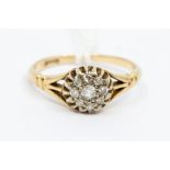 An 18ct gold diamond set dress ring, the central stone surrounded by eight further diamonds, claw