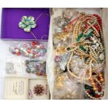 A collection of costume jewellery including brooches, necklaces, beads, earrings, faux pearls, circa