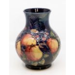 Moorcroft: A Moorcroft ovoid vase in Fruit and Bird pattern on blue ground. Height approx 23.5cm.