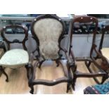 A Victorian armchair with two matching dining chairs, Victorian rocking chair and two other