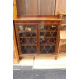 An Edwardian mahogany glazed bookcase, fitted with two doors enclosing three adjustable shelves,