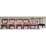 A set of four late Victorian mahogany dining chairs, of balloon back form, drop in seats, raised
