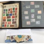 Two early 20th Century stamp albums, together with a collection of loose assorted stamps