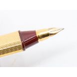 Cartier - a Must de Cartier ladies gold vermeil fountain pen, No. 57612, the oval cartridge pen with